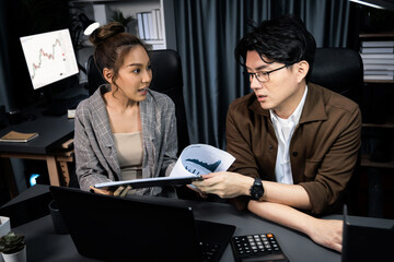 Two managers with stressful face discussing document paperwork file together comparing with report...