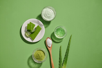 Aloe vera products: fresh leaves, gel, and creams arranged on a