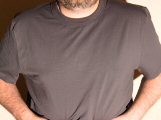 A male model wearing a gray T-shirt and a beard