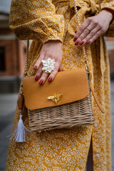 Fashionable Woman Holding Stylish Wicker Handbag