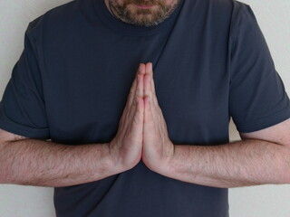 The concept of Zen. Calmness and balance within. A middle aged man's hands are folded in a boat...