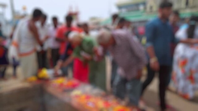 Bokeh view of devotees visit Sri Chamundeshwari Temple, located on Chamundi Hills near Mysore, India. Blurred background footage.