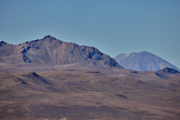 Naklejka premium The east face of Misti Volcano rises above the Arequipa landscape, its graceful cone and rugged slopes bathed in the clear light of the Andes