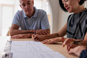 Woman signing contract at a table