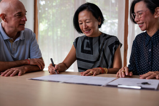Happy couple signing contract 