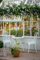 Charming Greenhouse Patio with Floral Decor