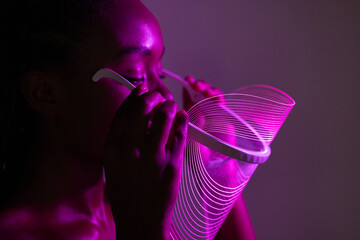 Holding a Futuristic LED Face Shield