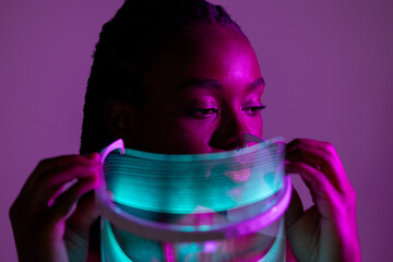 Holding a Futuristic LED Face Shield