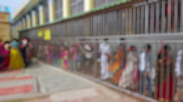 Bokeh view of devotees visit Sri Chamundeshwari Temple, located on Chamundi Hills near Mysore, India. Blurred background footage.