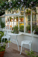 Charming Greenhouse Garden Seating with Floral Decor