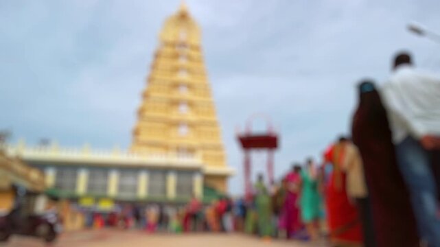 Bokeh view of devotees visit Sri Chamundeshwari Temple, located on Chamundi Hills near Mysore, India. Blurred background footage.