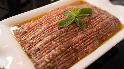 Succulent beef kibbeh nayeh, a Middle Eastern delicacy of finely minced raw beef with bulgur,...