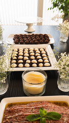 Elegant table setting with Lebanese kibbeh and Brazilian sweets (brigadeiro, beijinho). Perfect fusion for gourmet events, food photography and special celebrations.