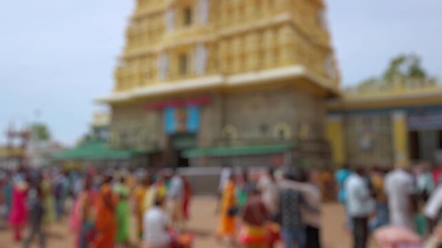 Bokeh view of devotees visit Sri Chamundeshwari Temple, located on Chamundi Hills near Mysore, India. Blurred background footage.