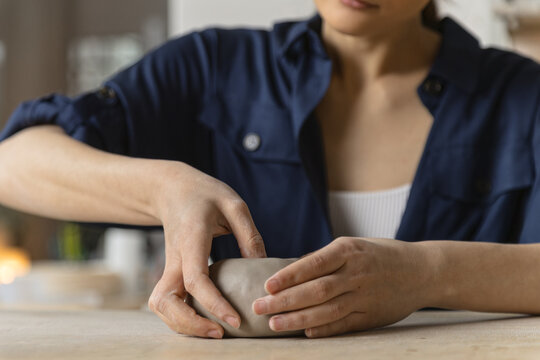 Female artisan hand making ceramic plate or bowl