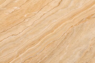 Close up of a beige and brown marble stone texture with natural veins and a smooth surface