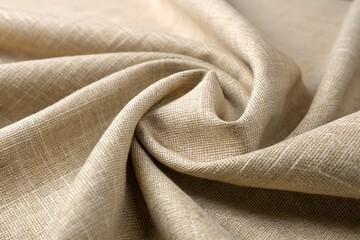 Fototapeta premium Closeup of a natural beige linen fabric with a soft texture, showing intricate weave and elegant folds