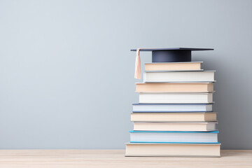 Stack of textbooks with graduation cap, back to school sale banner space, marketing-ready image