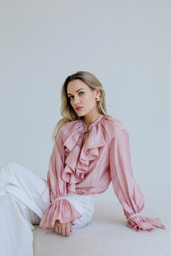 fashion portrait of blond woman in pink blouse