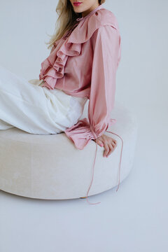 Anonymous woman in elegant pink blouse