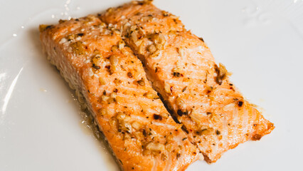 Juicy oven-baked salmon with garlic and herbs, perfectly seasoned and golden. A delicious, healthy dish for food photography, recipes, and gourmet content.