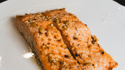Juicy oven-baked salmon with garlic and herbs, perfectly seasoned and golden. A delicious, healthy dish for food photography, recipes, and gourmet content.