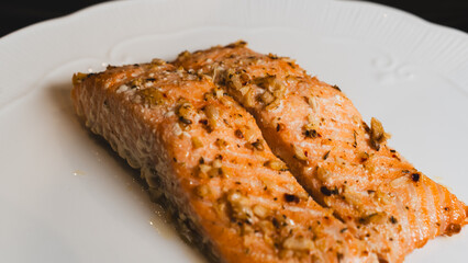 Juicy oven-baked salmon with garlic and herbs, perfectly seasoned and golden. A delicious, healthy dish for food photography, recipes, and gourmet content.