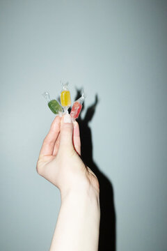 Hand holding colourful wrapped sugar sweet candy with flashlight