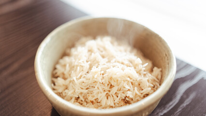 Fluffy white basmati rice steaming fresh from the pot. Perfectly cooked grains for food photography, recipe blogs, and Asian/Indian cuisine content