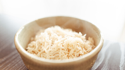 Fluffy white basmati rice steaming fresh from the pot. Perfectly cooked grains for food photography, recipe blogs, and Asian/Indian cuisine content