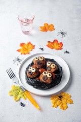 Meatballs with black pasta in the plate for Halloween