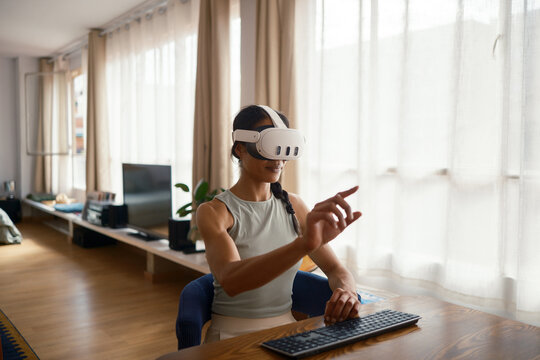 Woman using VR glasses at home