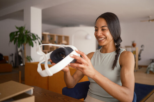 Woman unboxing VR glasses at home