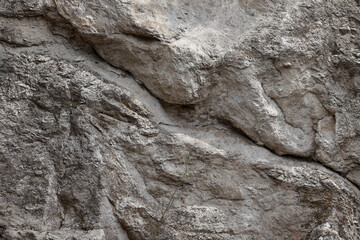 Close Up Texture Background Of A Weathered Grey Rock Surface With A Prominent Diagonal Crack. Natural Stone Pattern.