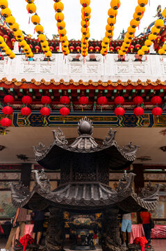 Lanterns above Chinese ornate temple entrance
