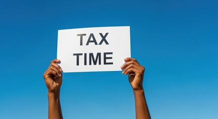 Tax Time Announcement: Hands Holding Sign Against Blue Sky Background for Financial Planning