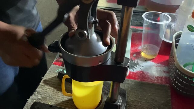 Fresh Orange Juice Being Squeeze using a special orange squeezer at Street Food Stall