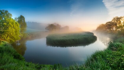 Obraz premium a tranquil river disappearing into the mist creating a surreal and peaceful scene