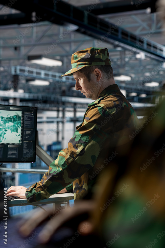 Poster soldier in server hub checking reports at data operations workstation monitor. army information expe