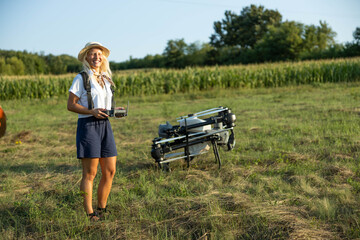 A cheerful woman poses beside her drone with a broad smile, signifying her passion for technology...