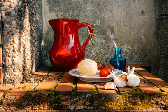 Decorative Table Setup With Fresh Ingredients and Colorful Pottery