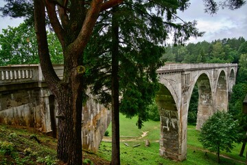 An old high bridge between forests.