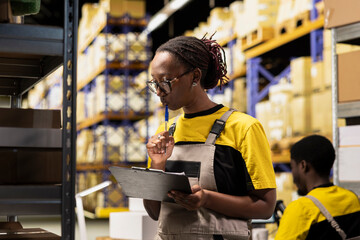 African american worker processing merchandise for business logistics system, busy distribution hub...