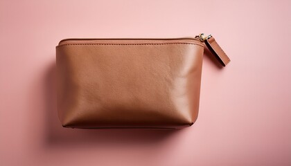 Obraz premium brown cosmetic bag on soft pink background
