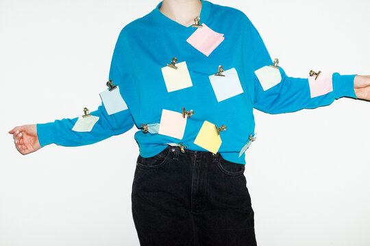 Person having post it notes in the shirt in business office with flash