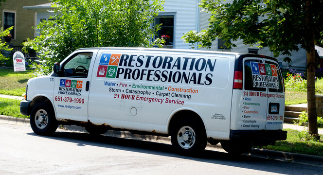 Restoration Professionals truck in the neighborhood restoring homes after environmental damage like water, fire and storms. St Paul Minnesota MN USA