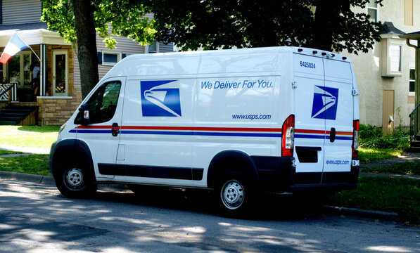 United States Postal Service mail truck parked in the neighborhood supporting mail carrier delivering the mail. St Paul Minnesota MN USA