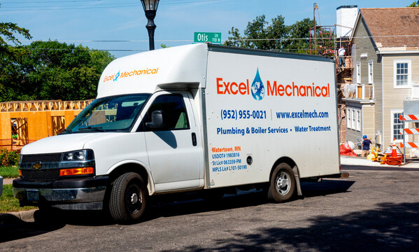 Excel Mechanical truck parked beside a new addition of homes probably dealing with heating and or plumbing installations. St Paul Minnesota MN USA