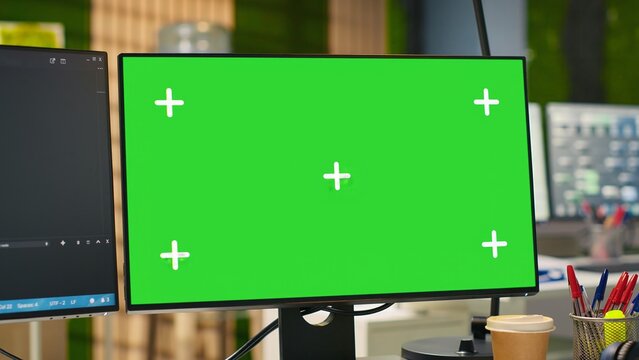 Empty startup office with green screen PC and artificial intelligence program running on monitors. Mockup computer display in AI industry startup workspace leveraging machine learning technology
