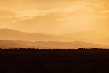 Golden sunset over Altai mountains Russia - captivating layers of misty mountain ridges
